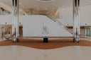 Modern indoor setting with a staircase and artwork on a white wall.