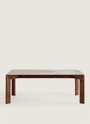 Detailed view of the clean architectural lines and solid wood joinery on the Juntowd Palmares bespoke stone-top table.
