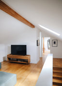 The Caria Sideboard used as a custom furniture TV stand, combining open shelf storage with a light, modern profile.
